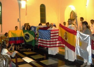 Fr. Boquet holds U.S. flag during Mass at the Congress.