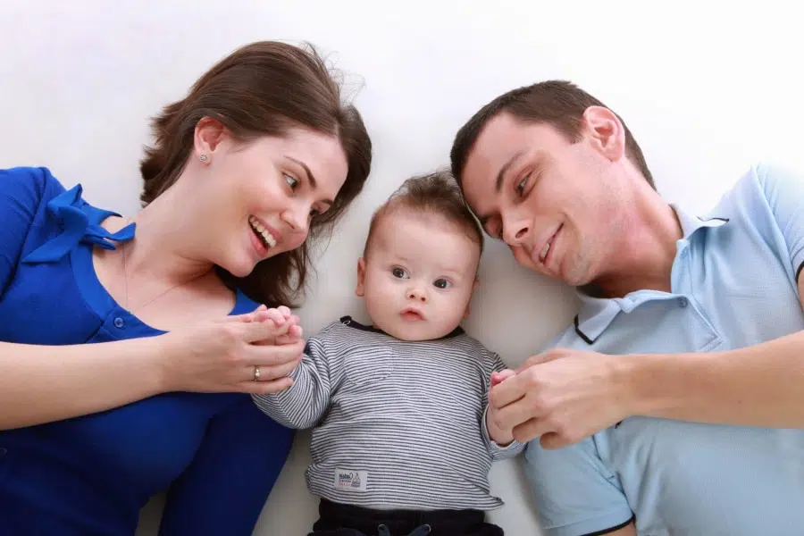 happy parents with baby between them