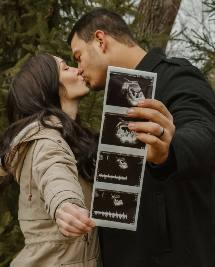 A husband and wife celebrate their unborn baby.