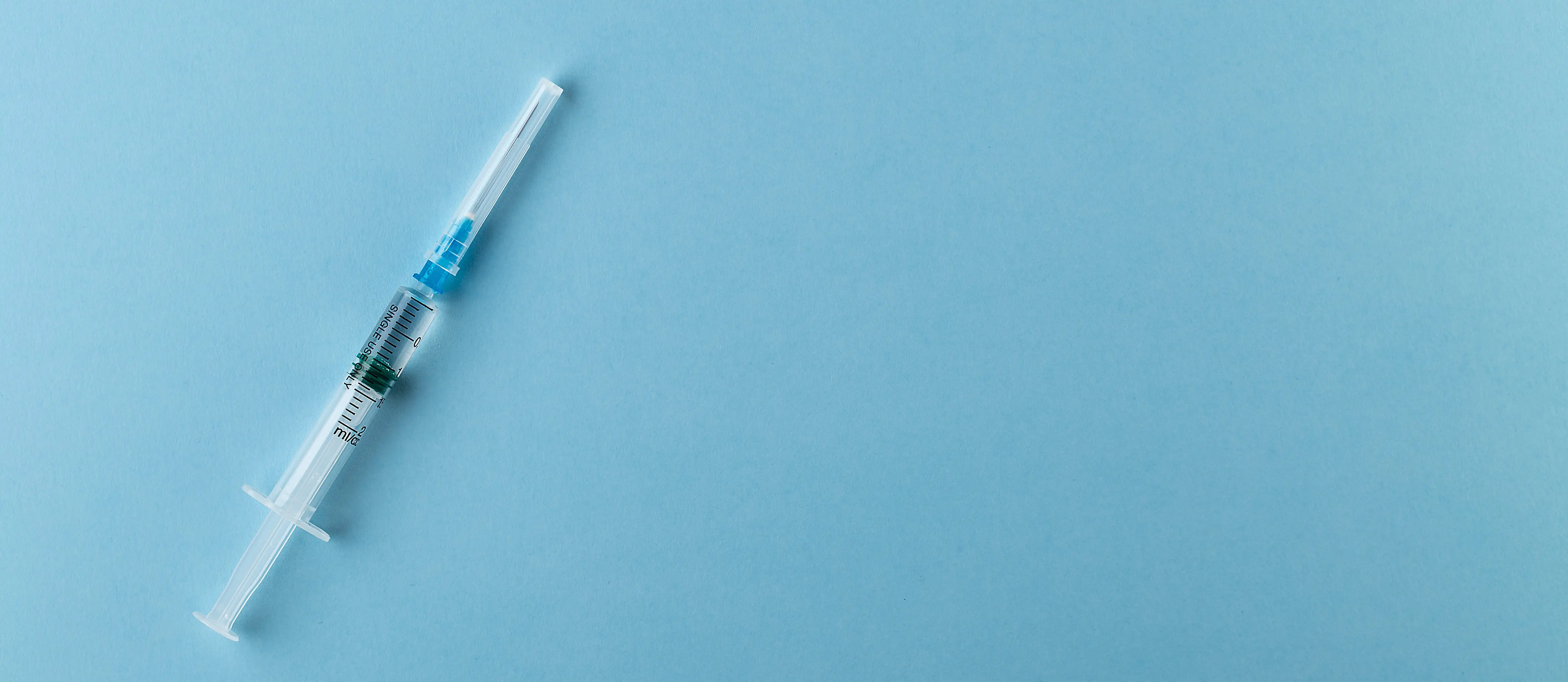 syringe blue background, depo-provera shot