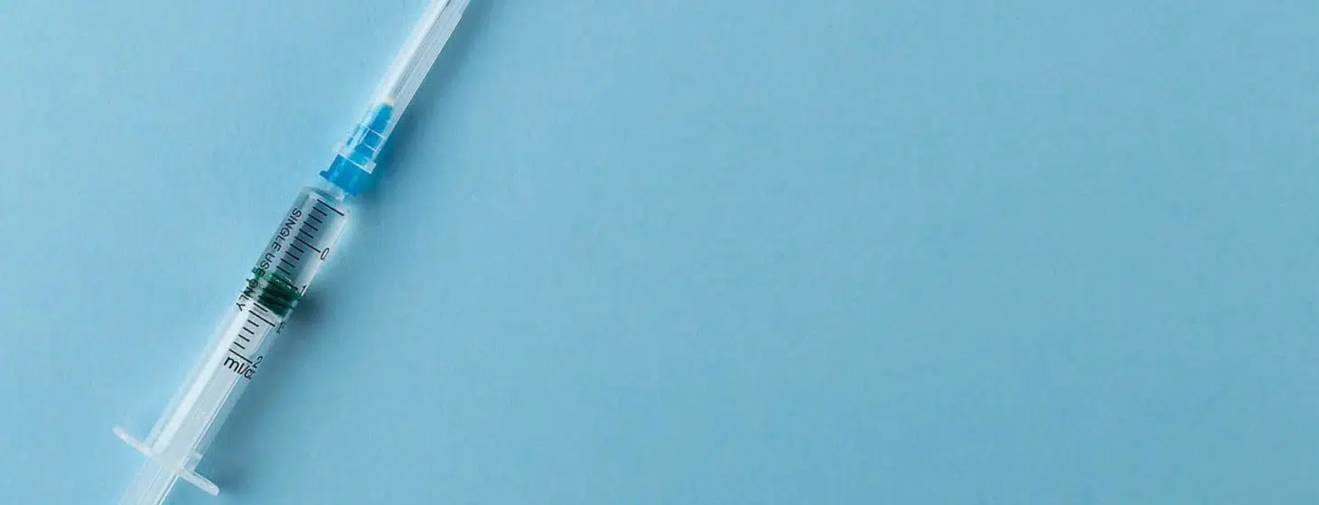 Syringe on a blue background