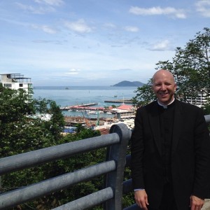 Fr. Boquet in Kota Kinabalu, Malaysia at an observation point overlooking downtown and the China Sea.