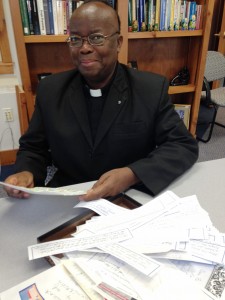 Fr. Wanjohi with letters of encouragement and support from recent campaign.