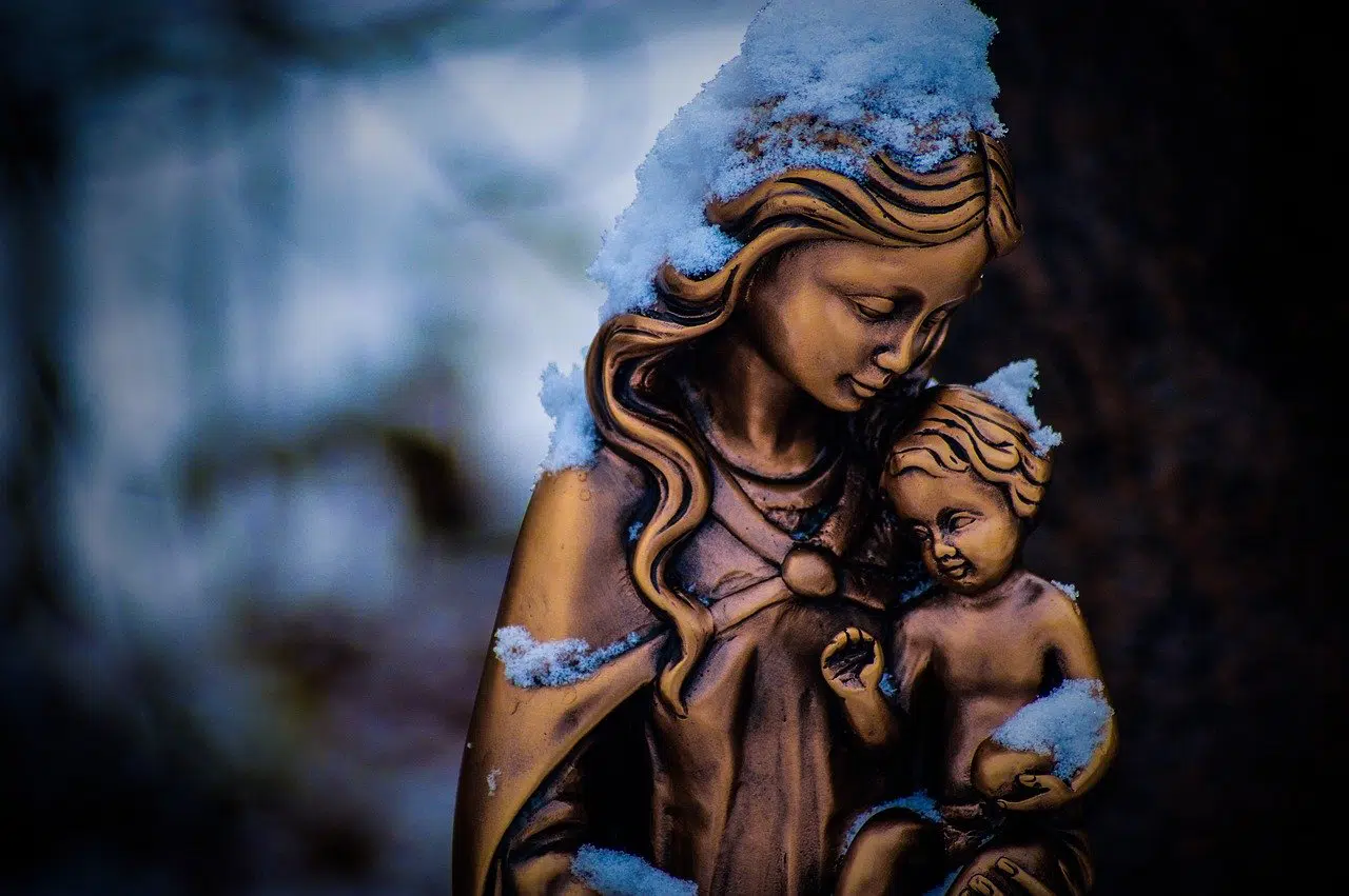 blessed mother with child Jesus bronze statue in snow