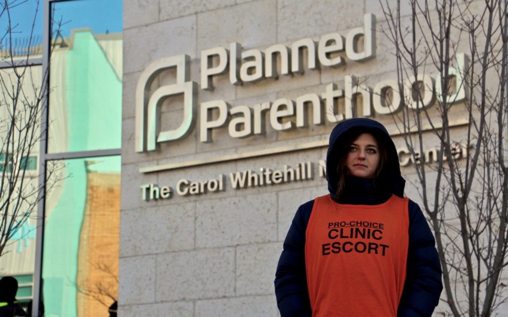 planned parenthood abortion clinic with clinic escort outside