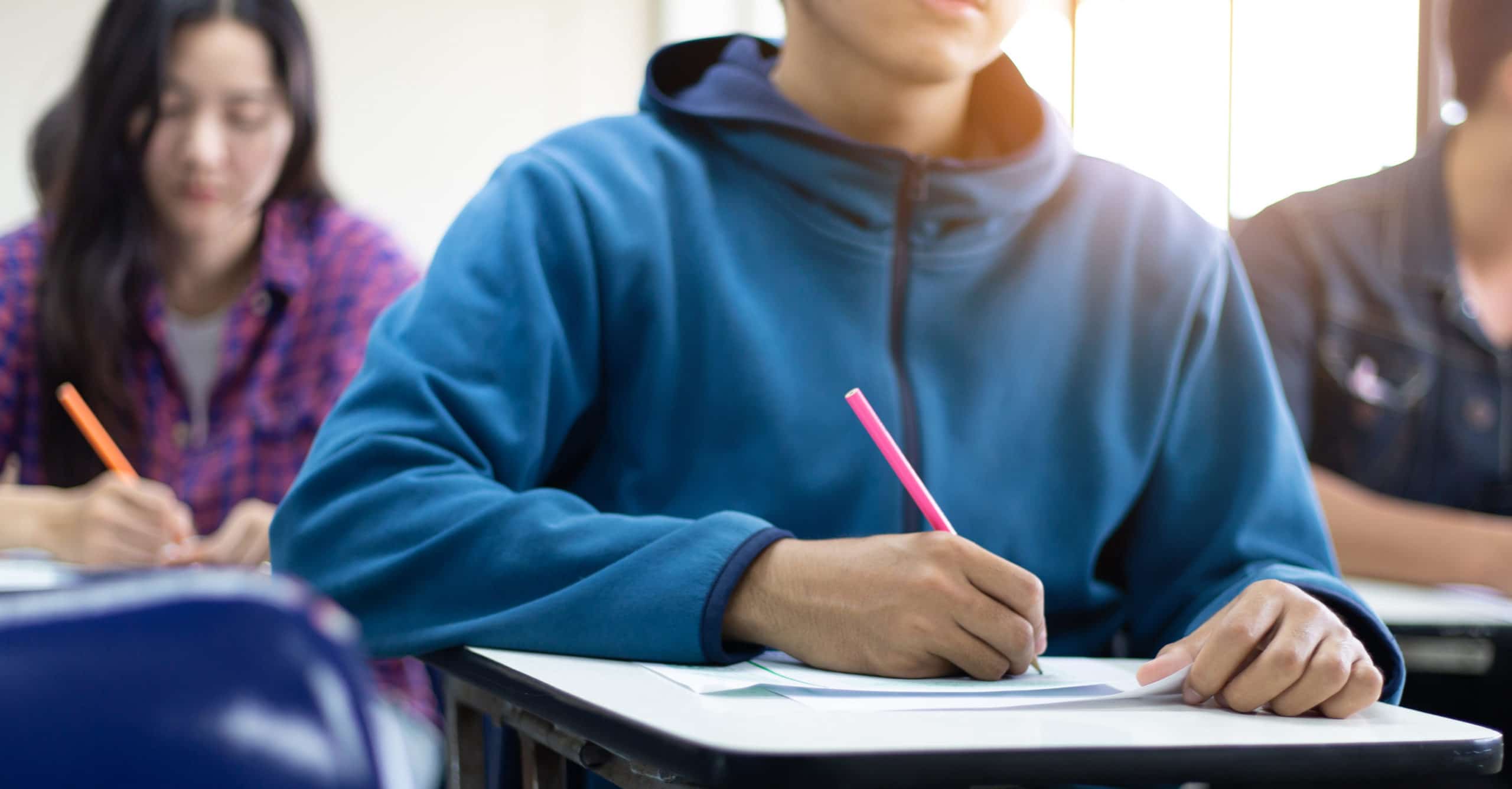 teens in class taking notes