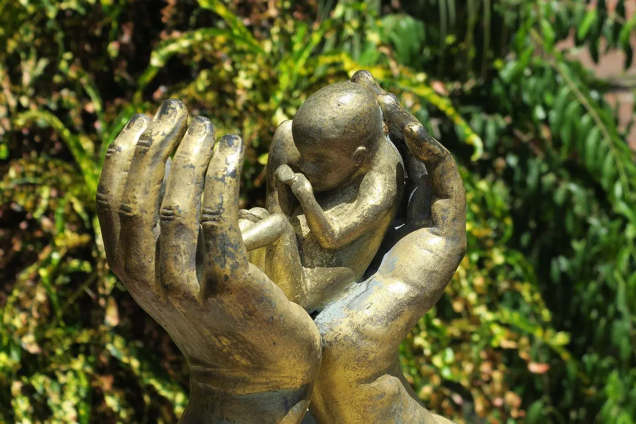 statue hands holding unborn child right to life pro life anti abortion