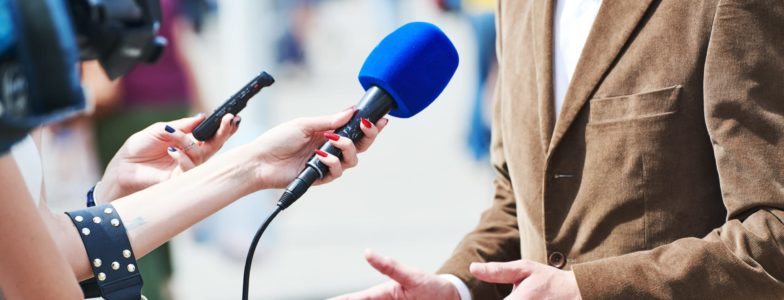 media reporter with microphone making journalist interview for news