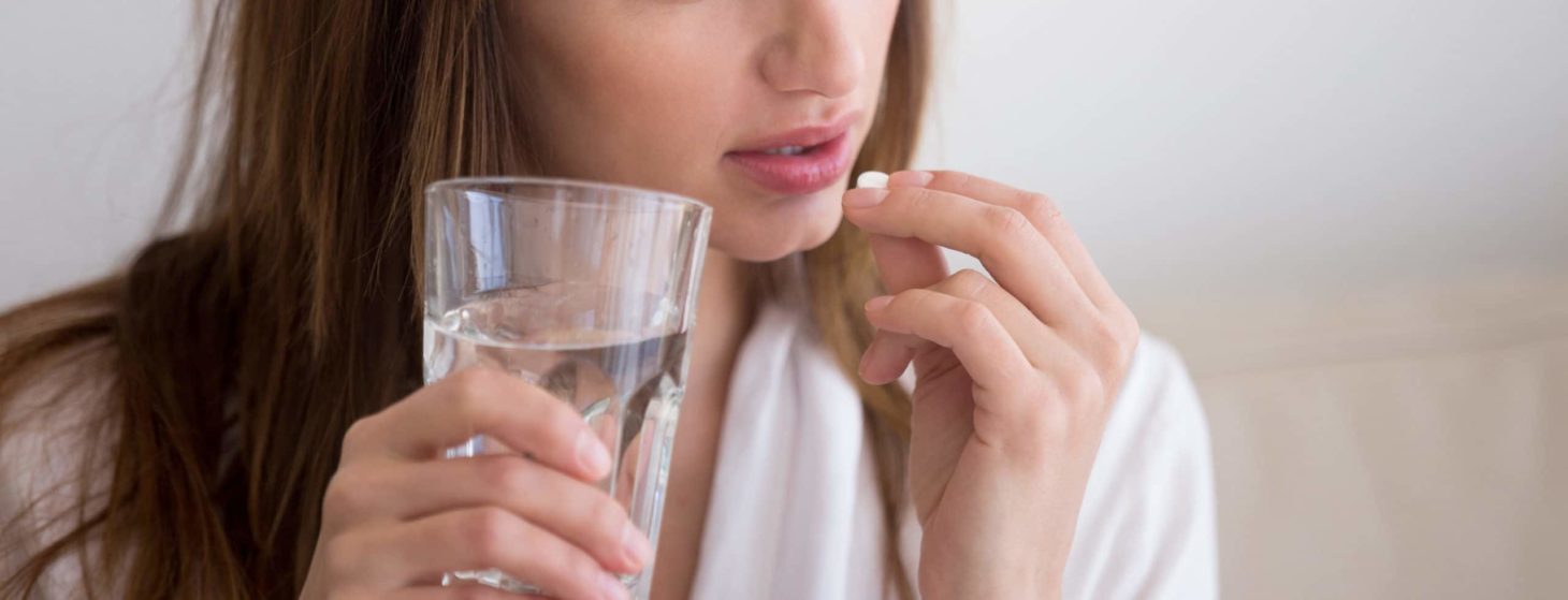 woman about to take pill