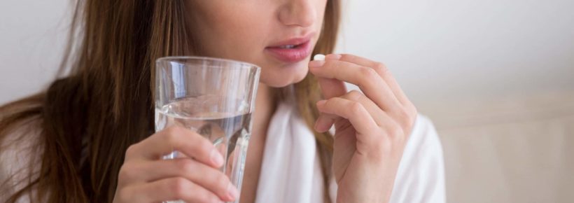 woman about to take pill