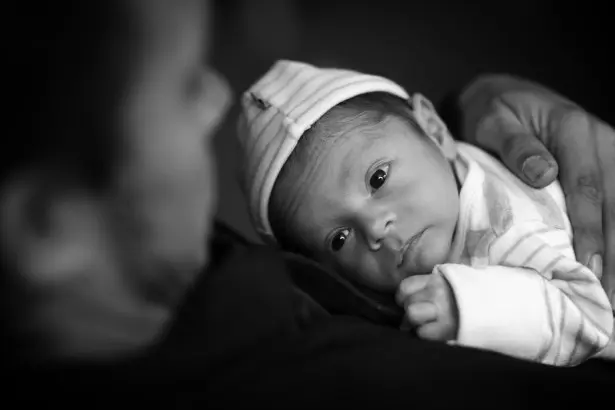 newborn with dad black and white