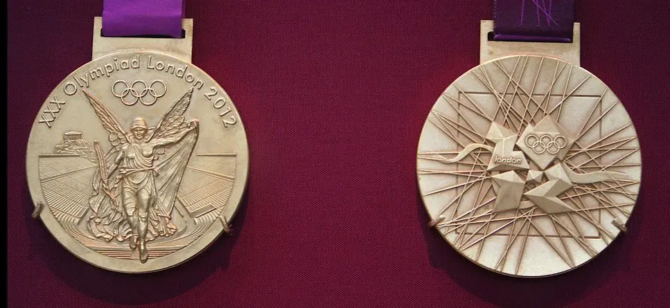 two olympic gold medals on red background