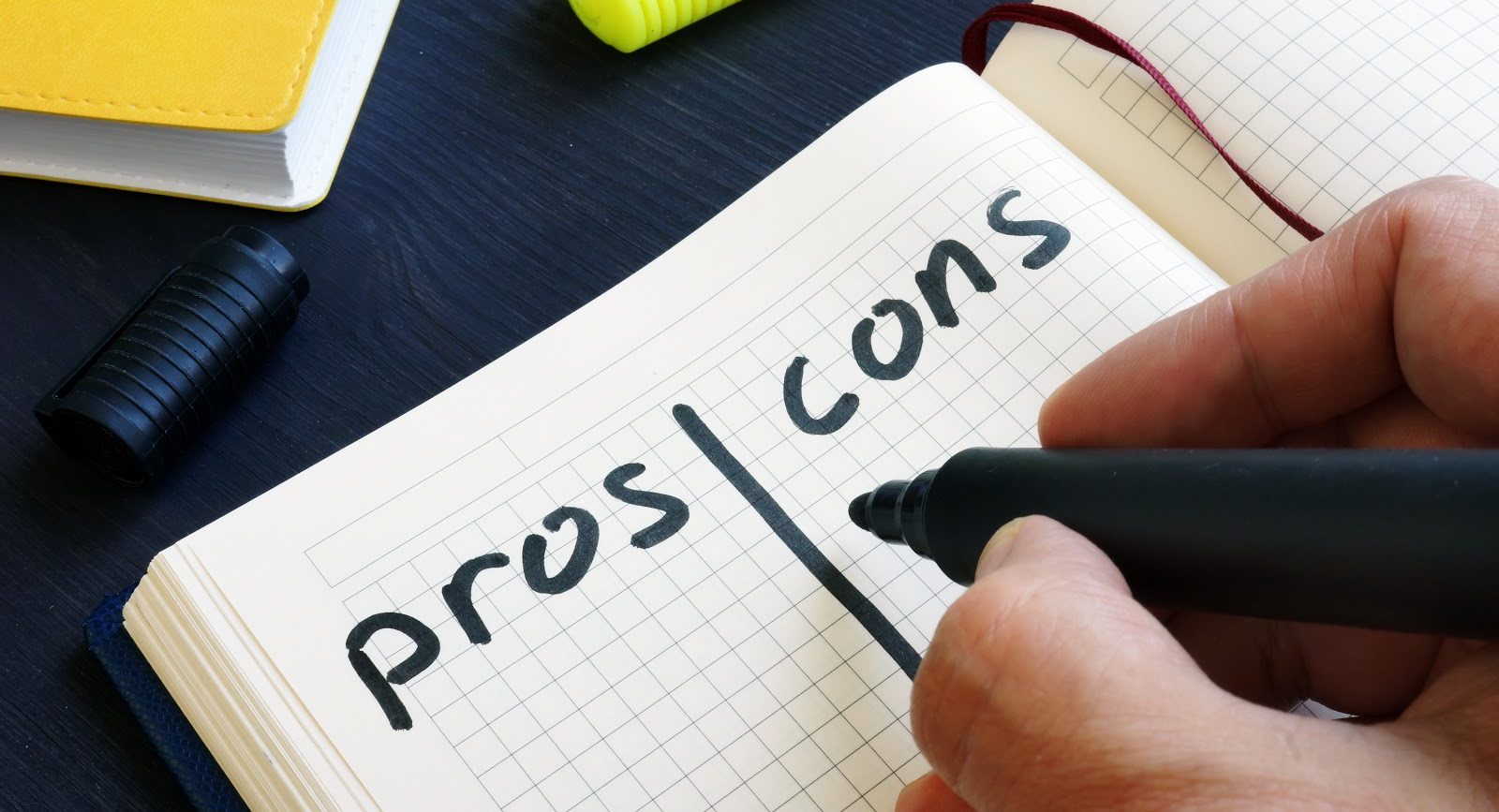 man writing list of pros and cons