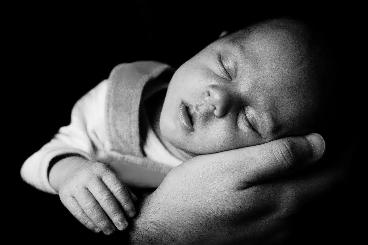baby sleeping black and white