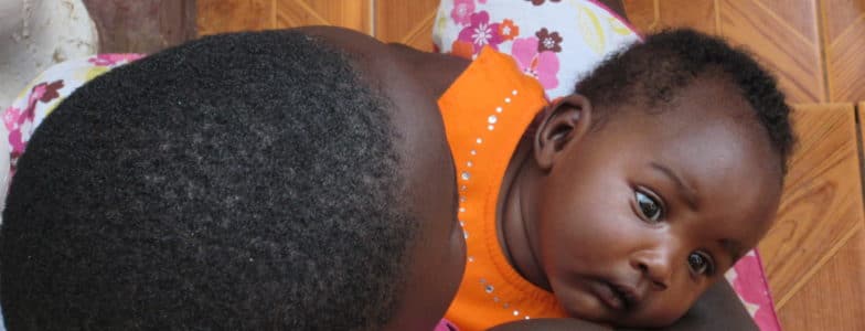 african mom holding baby