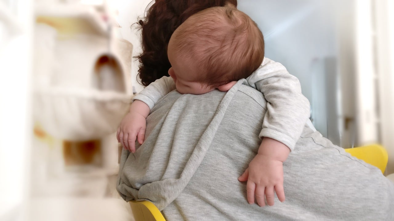 baby asleep on mom's shoulder