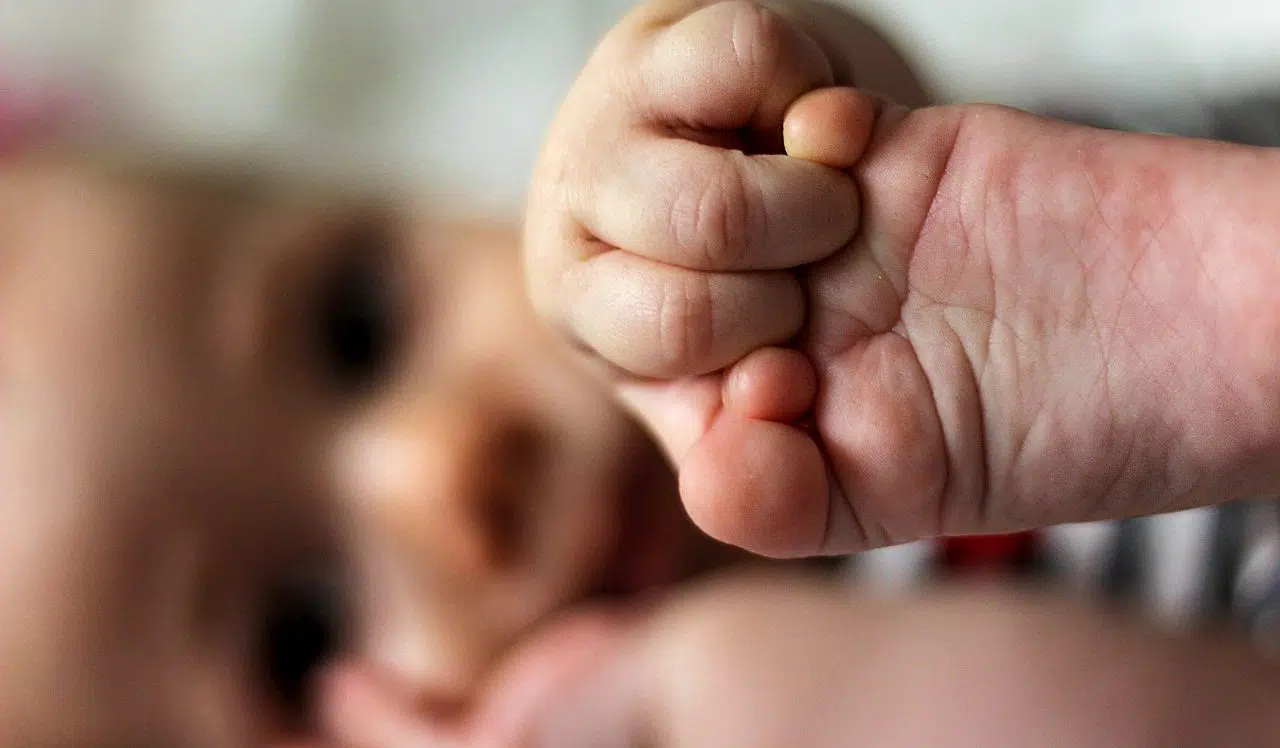 baby holding his foot