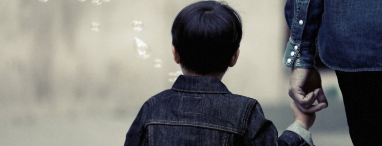 boy holding parent's hand