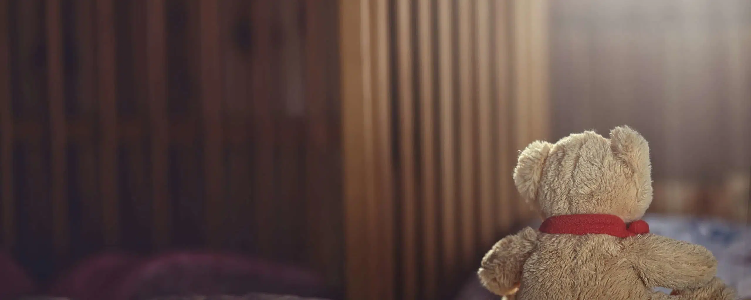 Teddy bear in an empty child's room