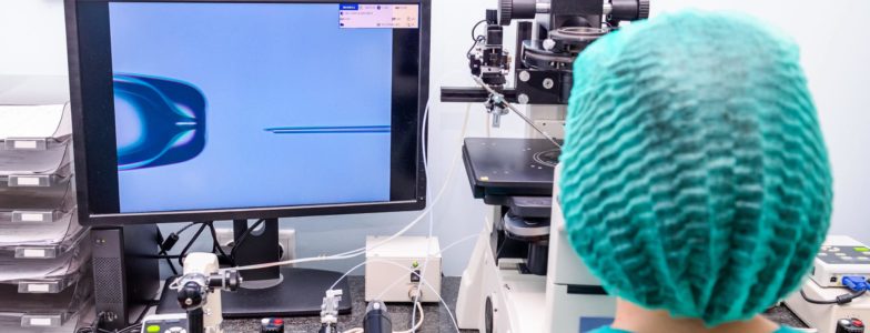 Embryologist adding sperm to egg in laboratory of reproductive clinic. Selective focus