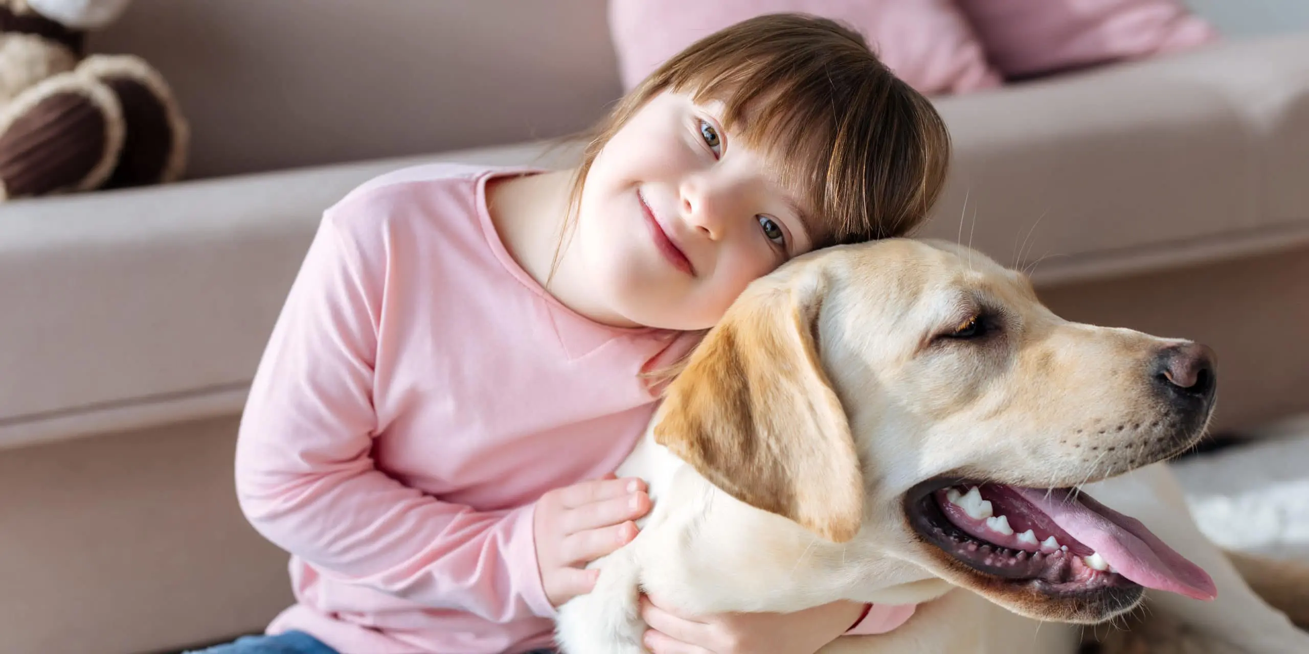 Child with down syndrome cuddling with dog