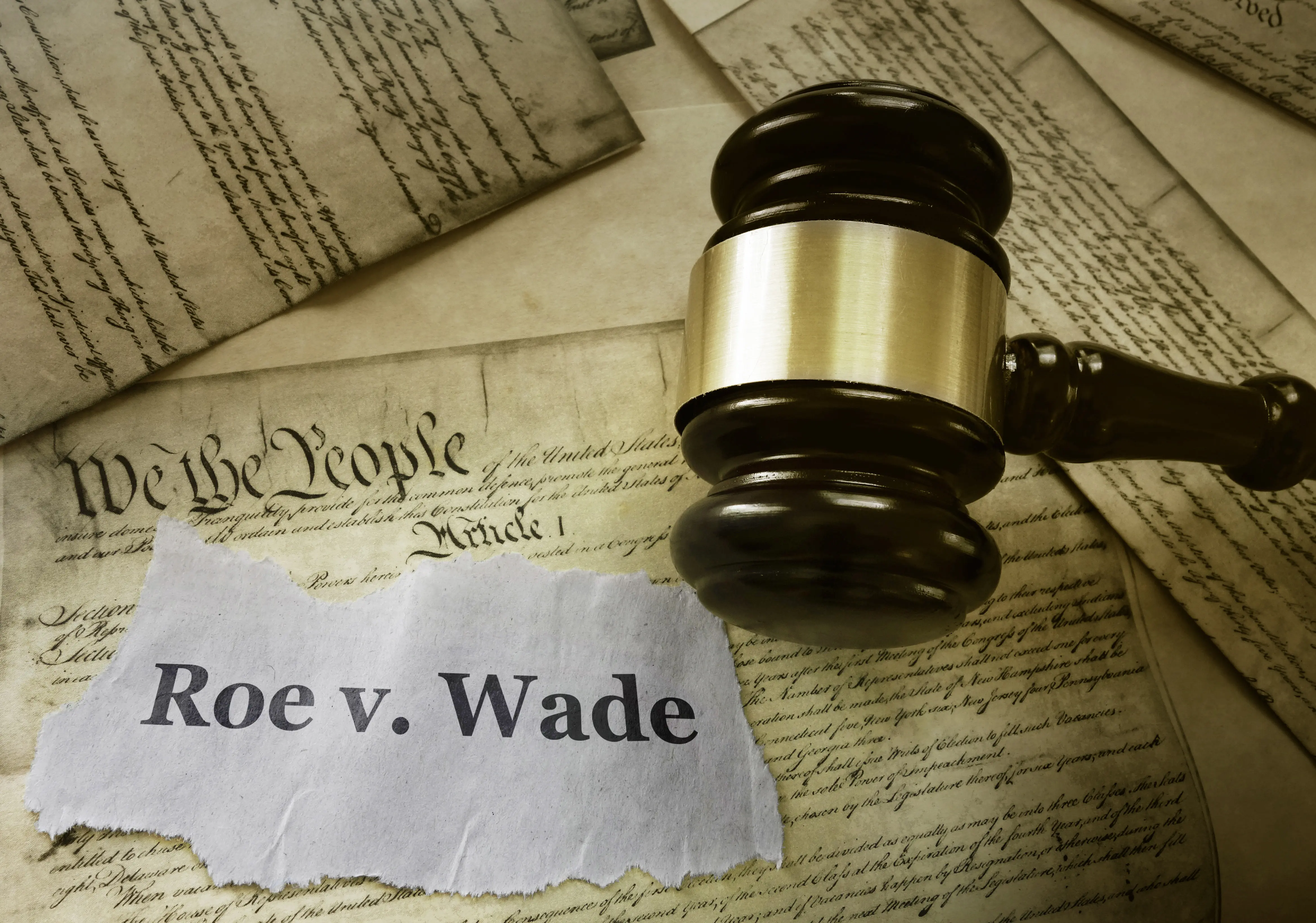 Roe v Wade news headline with gavel on a copy of the United States Constitution legalization of abortion