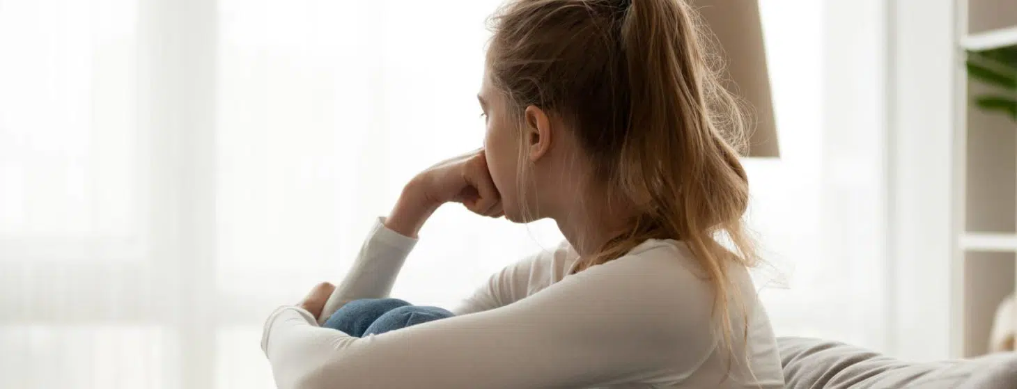 woman sad pensive looking out window