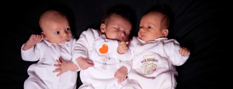 baby triplets black background