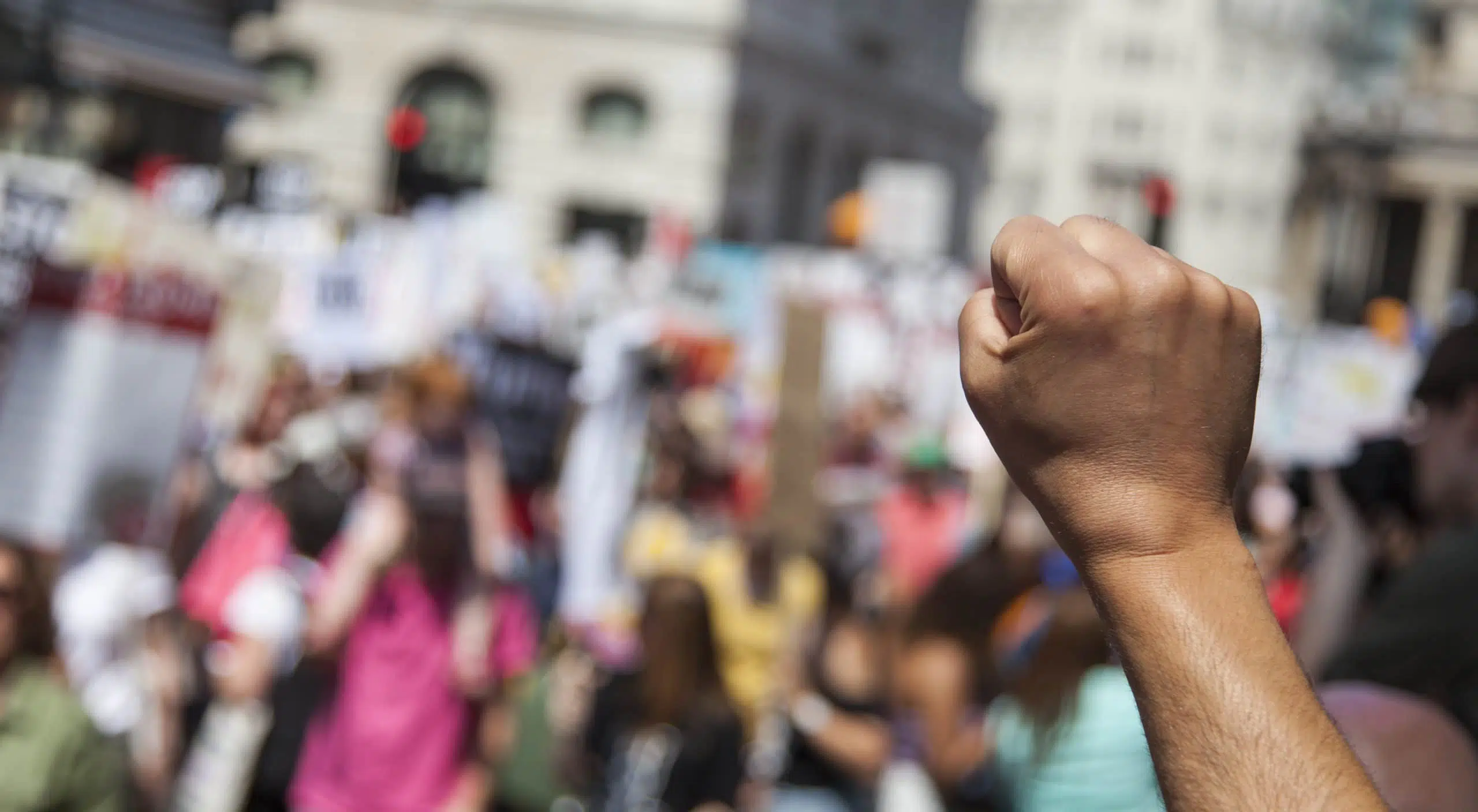 A raised fist of a protestor at a political demonstration