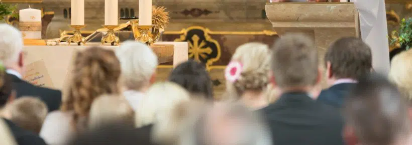 priest giving homily sermon, people listening, in church, catholic Mass