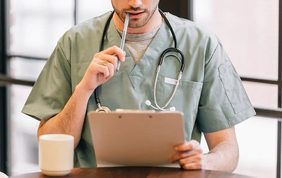 doctor looking at clipboard