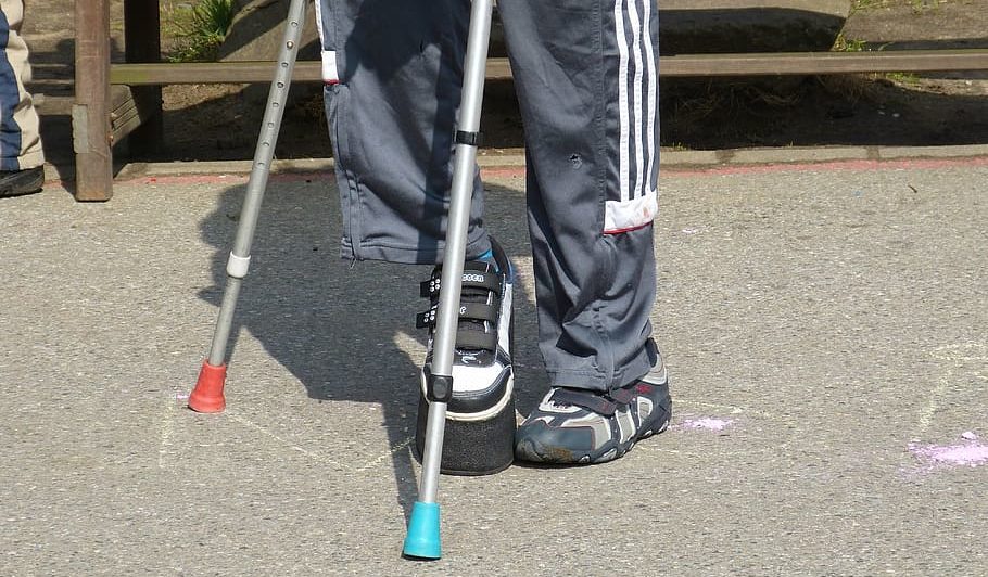 man using crutches