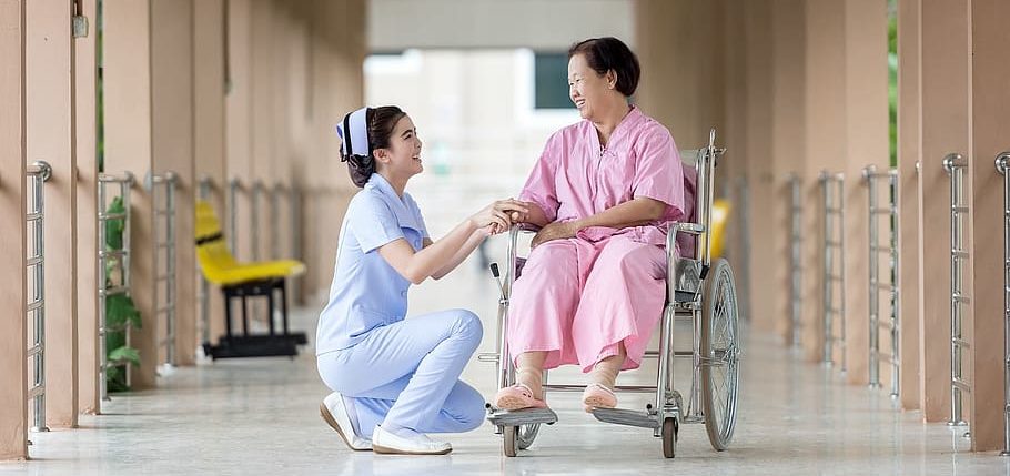 nurse helping elderly woman