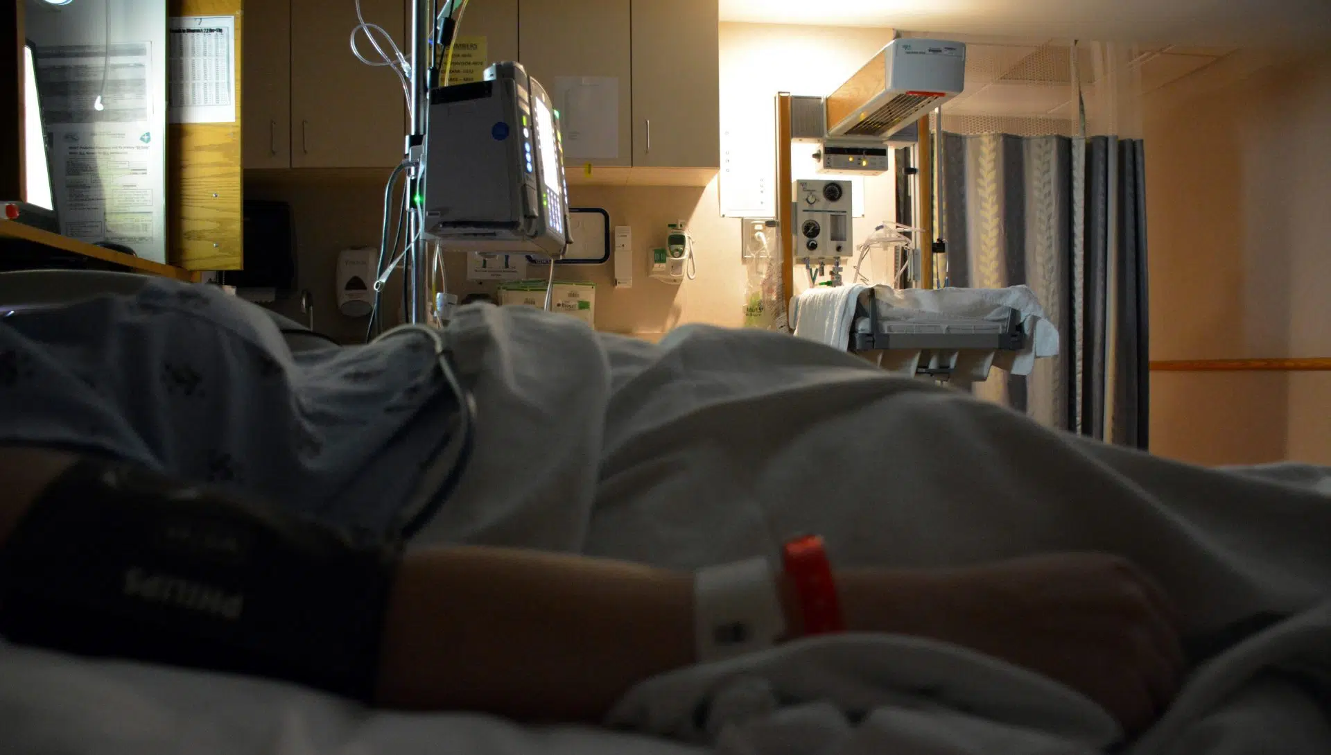 person lying in hospital bed