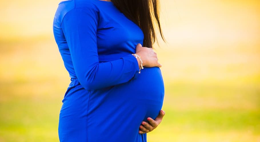 pregnant woman third trimester blue dress