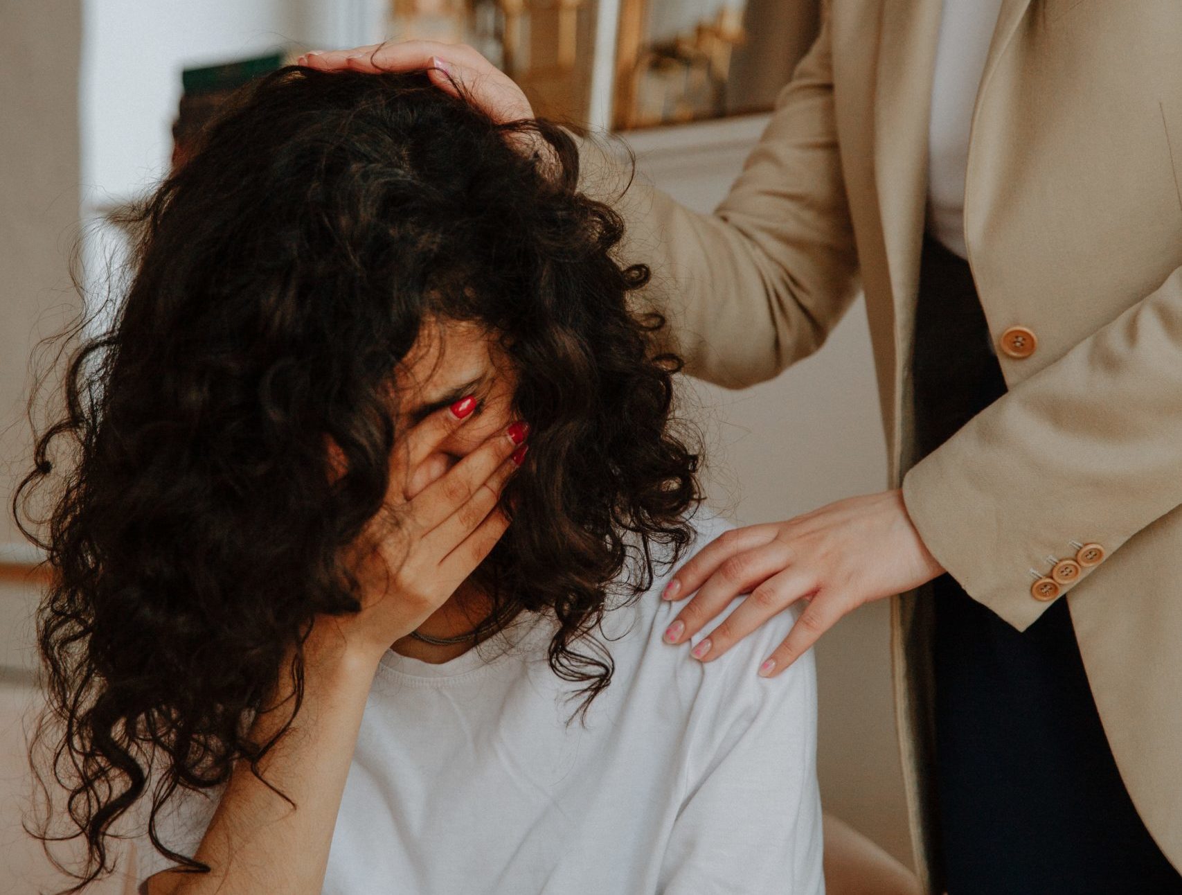 therapist comforting woman, sad