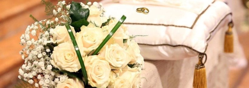 marriage roses bouquet and rings on pillow