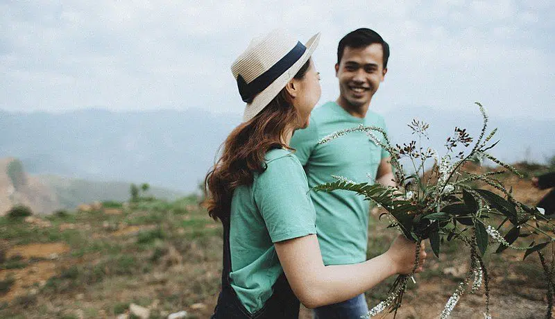 happy couple smiling with flowers