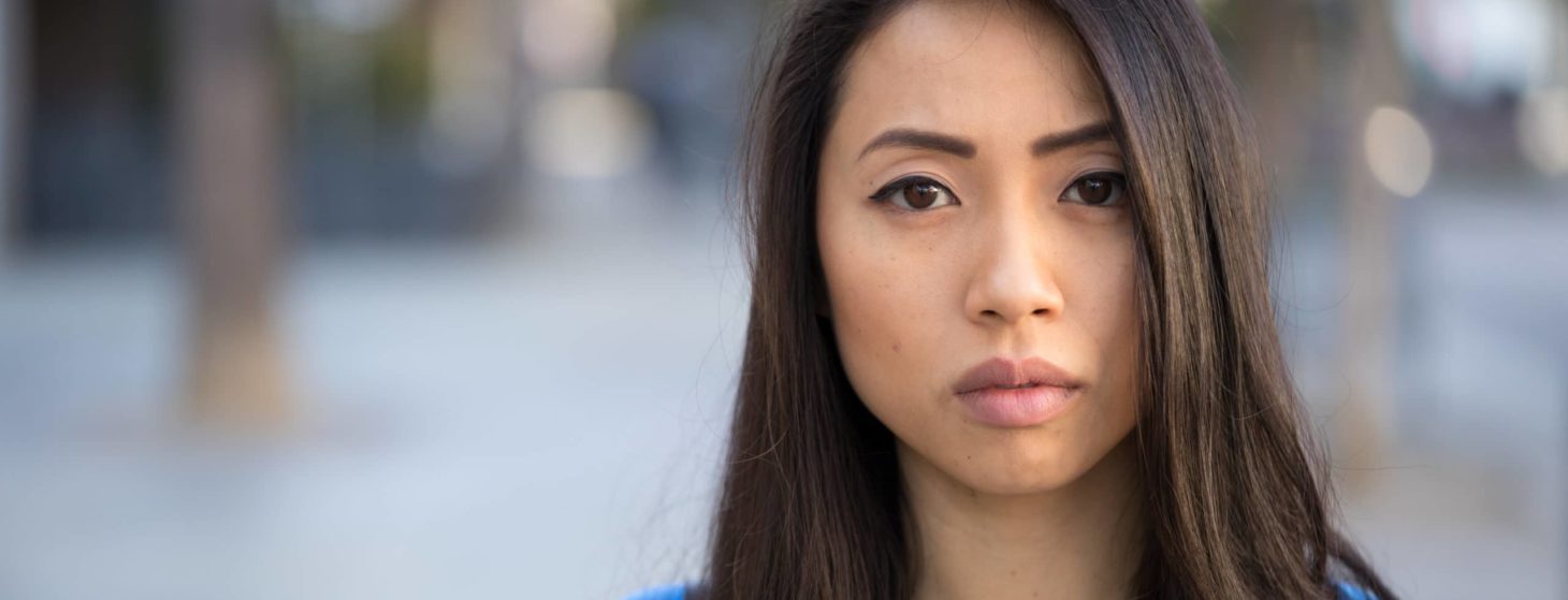 Young Asian woman serious face