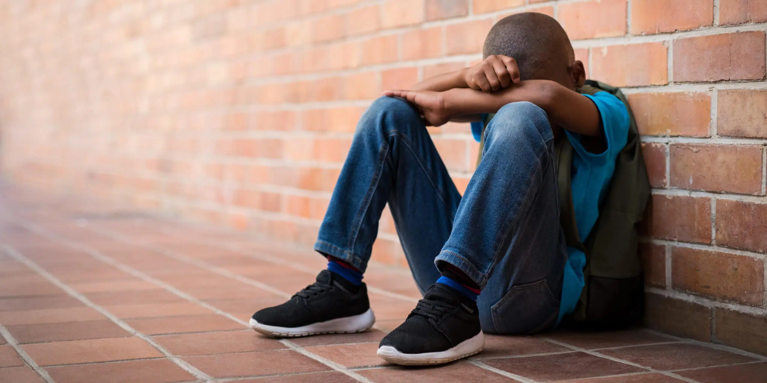 boy sitting sad, bullied