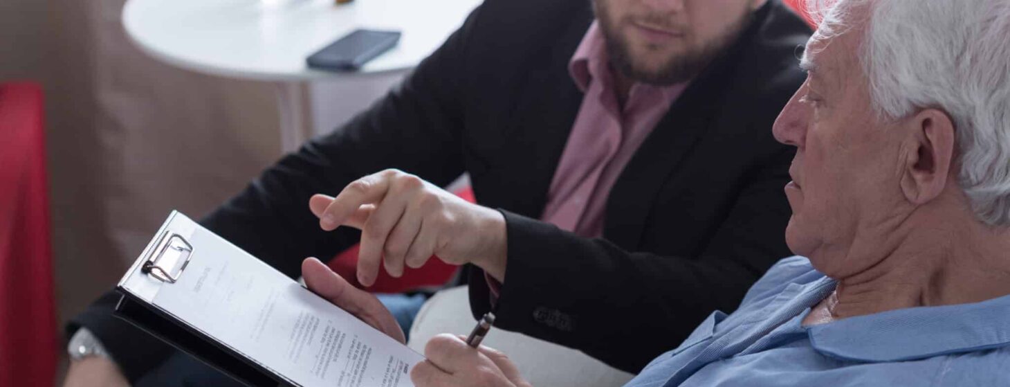 patient signing last will and testament with lawyer