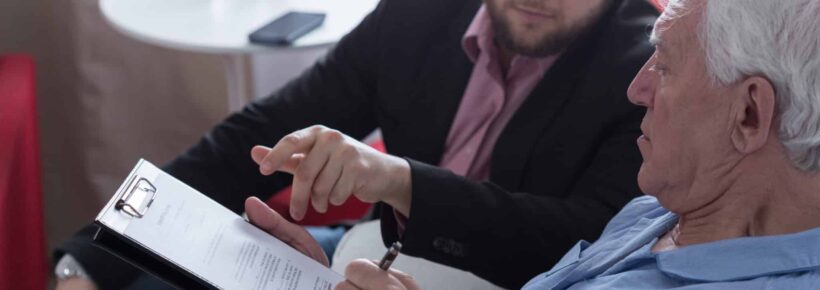 patient signing last will and testament with lawyer