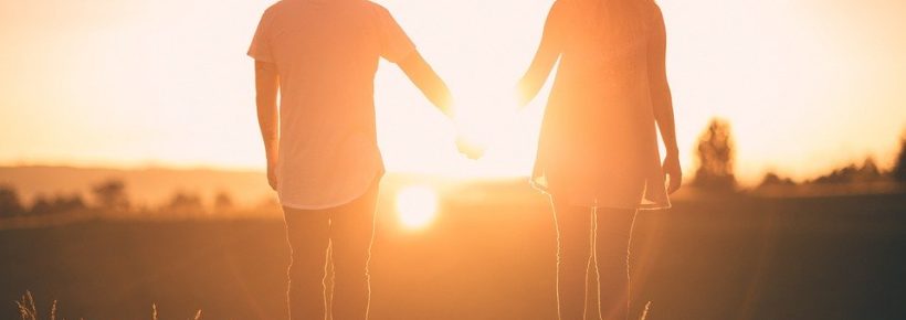 couple holding hands in sun