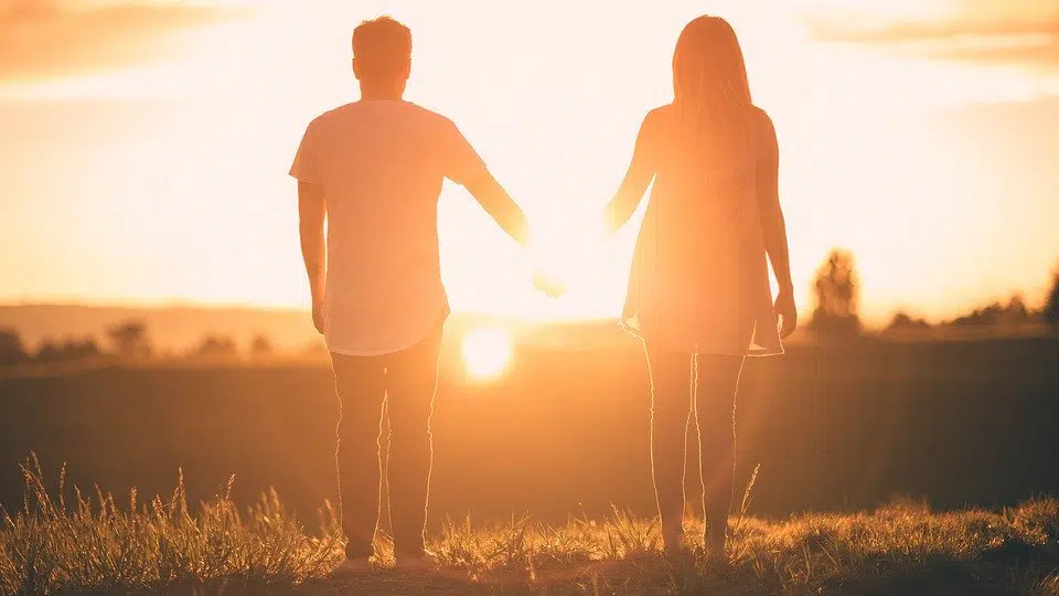 couple holding hands in sun