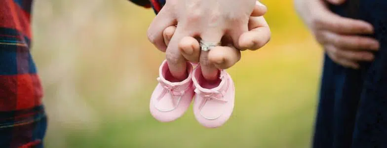 Couple with baby shoes