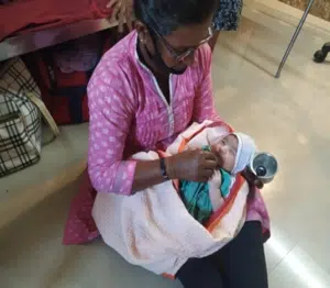 HLI missionary in India caring for a baby
