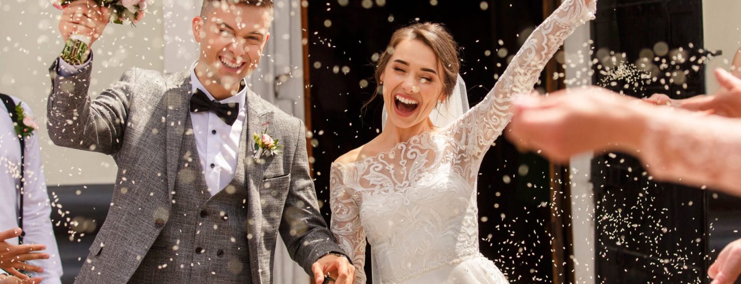 Happy wedding photography of bride and groom at wedding ceremony. Wedding tradition sprinkled with rice and grain