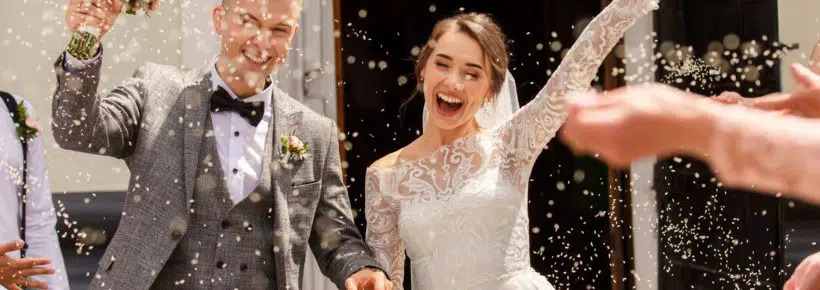 Happy wedding photography of bride and groom at wedding ceremony. Wedding tradition sprinkled with rice and grain