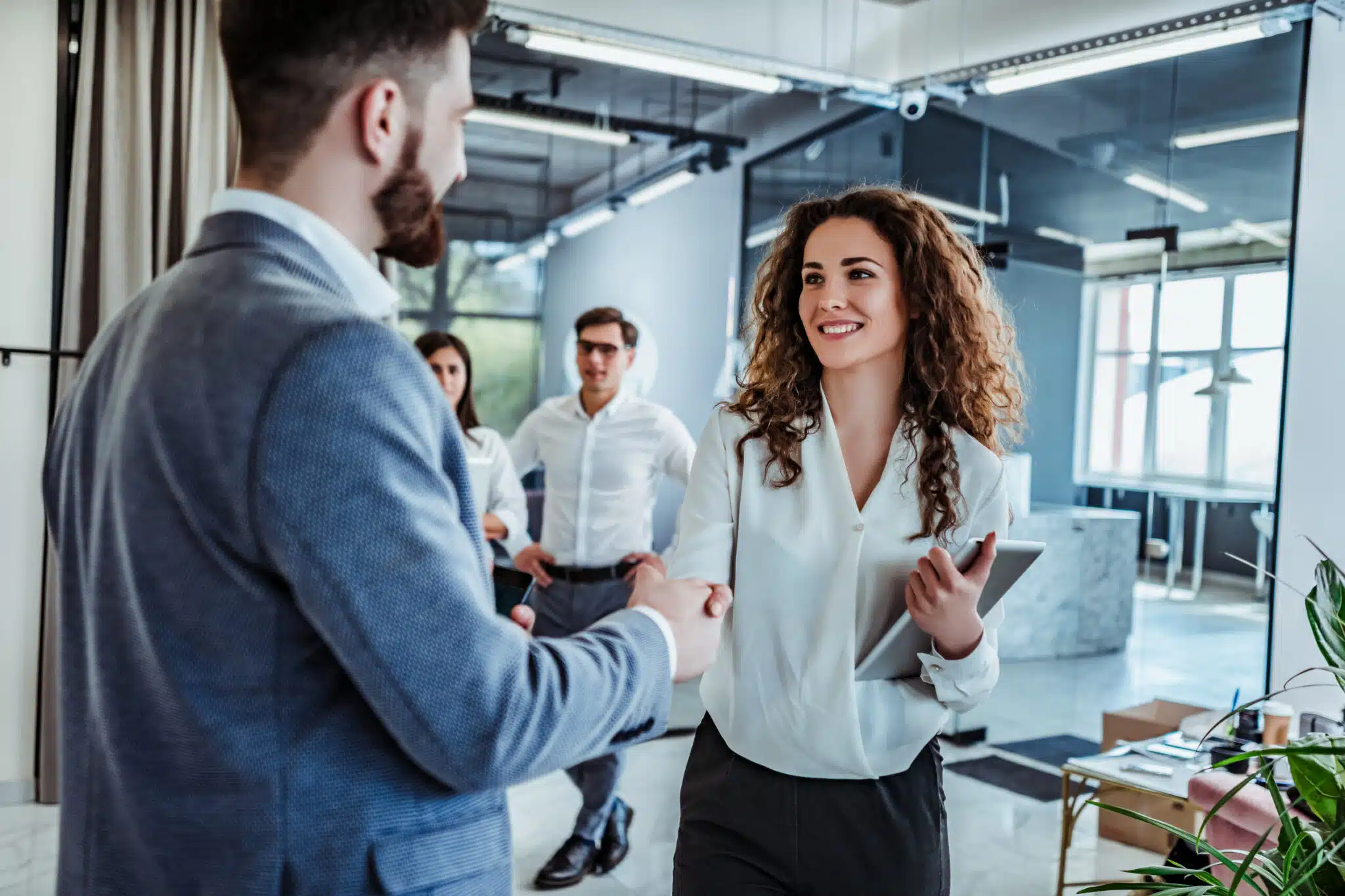 Man and woman are shaking hands in office. Collaborative teamwork. Business professionals