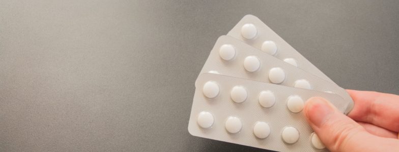 Contraceptive pills pack on gray background